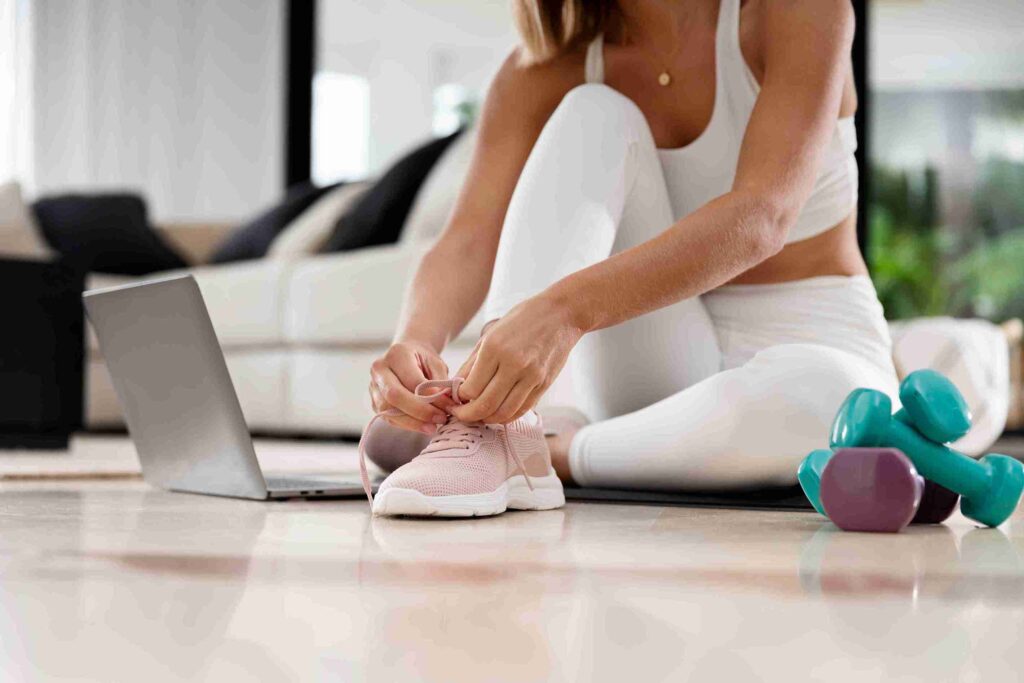 close-up-woman-tying-shoelaces_11zon